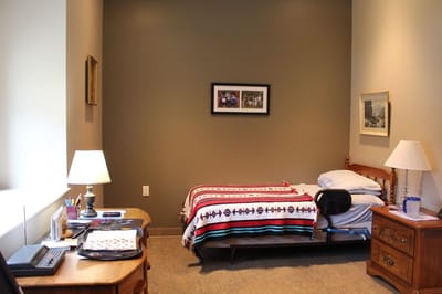 Cozy resident room with a bed and personal items