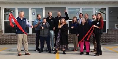 Residents and staff celebrating at a ribbon-cutting event