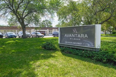 Facility sign with name displayed in a green outdoor setting