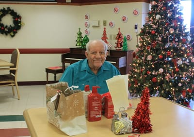Resident sitting in a decorated common area during the holidays