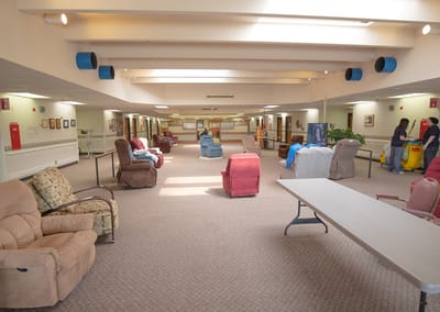 Common area with seating and residents present