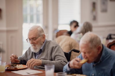 Residents enjoying meals in a dining area