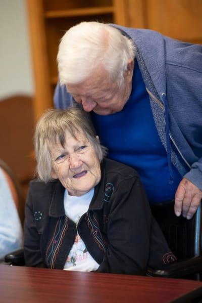 Two residents enjoying a moment together indoors