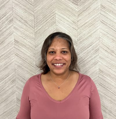Smiling staff member posing for a photo
