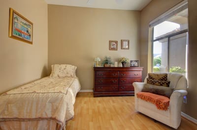 Cozy private resident room with a bed and dresser