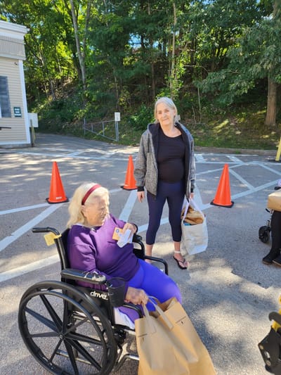 Residents receiving meals outside the facility