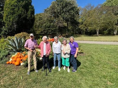 Residents posing in a garden with pumpkins
