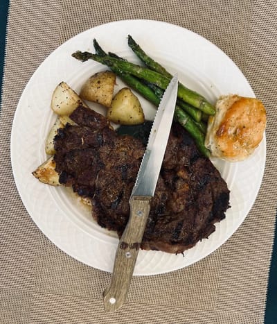 Plate of steak with potatoes and vegetables