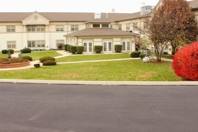 Exterior view of Cedar Hills Retirement Center with gardens