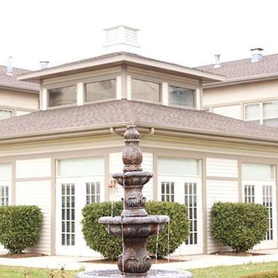 Exterior view of Cedar Hills Retirement Center with fountain