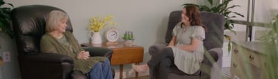 Resident and staff member engaging in conversation