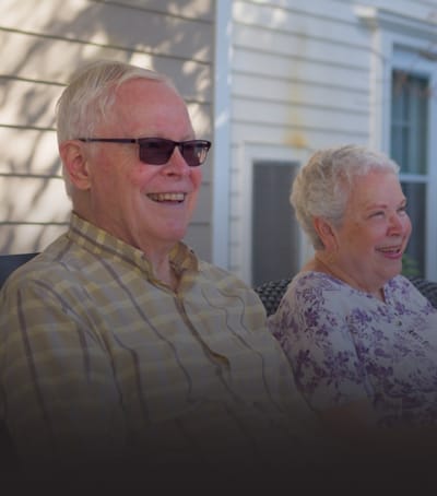 Two smiling seniors enjoying time together outdoors