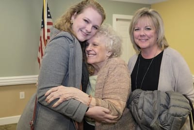 Residents enjoying a warm embrace in a common area