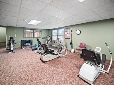 Fitness room with exercise equipment and carpeted flooring