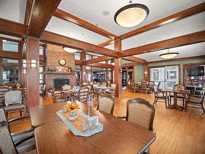 Common area with tables and chairs in a living facility