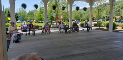 Residents enjoying an outdoor gathering with balloons