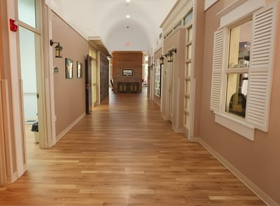 Hallway in a senior living facility with wooden flooring