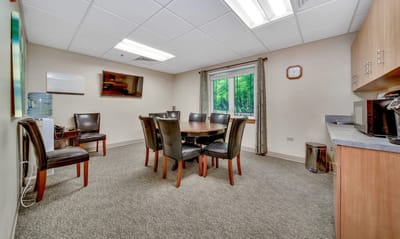 Bright common area with dining table and chairs