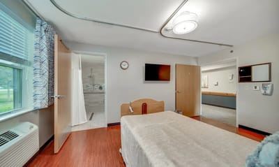 Private resident room with a bed and bathroom