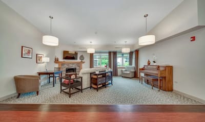 Bright interior common area with seating and piano