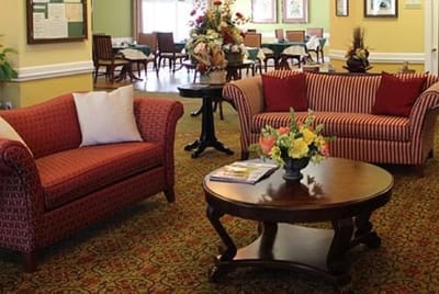 Bright common area with seating and floral arrangements