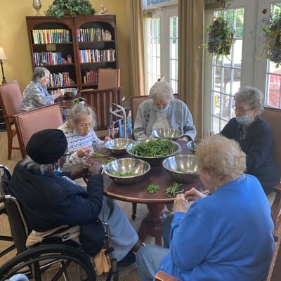 Residents engaged in a group activity, preparing food.