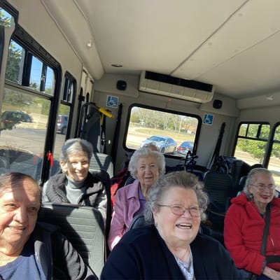 Seniors enjoying a ride in a facility shuttle bus