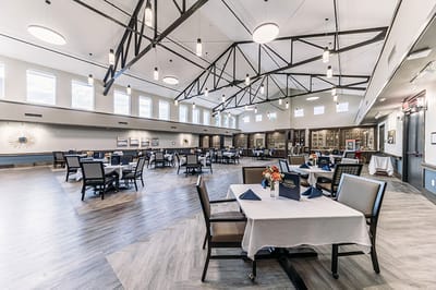 Dining area with tables and chairs set for meals