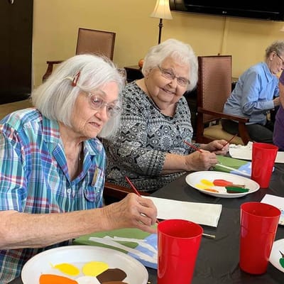 Residents painting in a common area activity