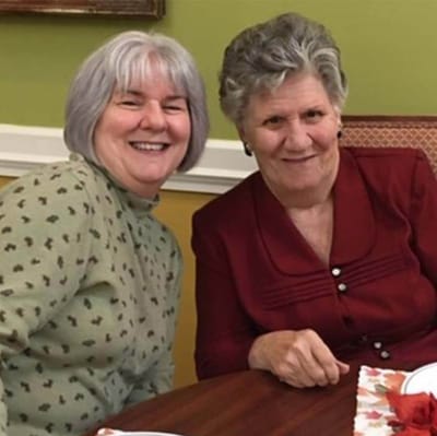 Two residents enjoying time together at a table