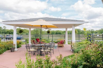 Outdoor shaded seating area with flowers