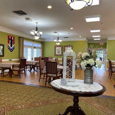 Interior of a dining room with tables and floral decorations
