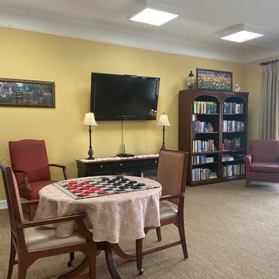 Common area with checkers game and bookshelves