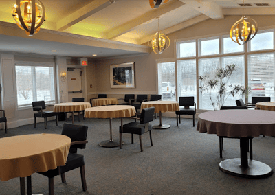 Interior view of a common area with round tables and chairs
