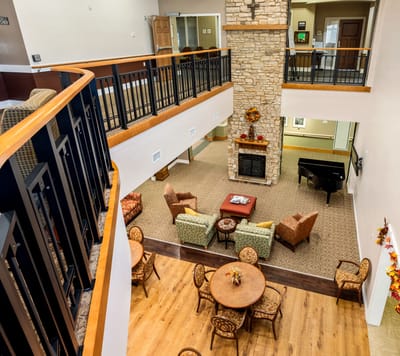 View of an interior common area with seating and a fireplace