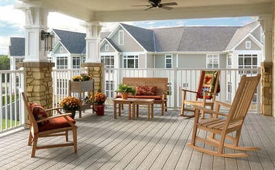 Outdoor seating area with rocking chairs and flowers