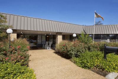 Front entrance of Cedar Creek Post Acute with landscaping