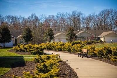 Well-maintained outdoor walking path with benches and landscaping.