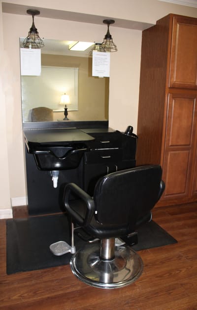 Beauty salon area with styling chair and mirror