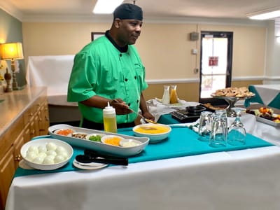 Chef preparing a meal in a dining area