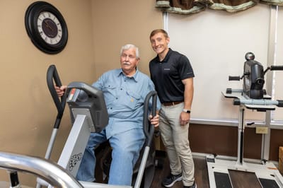 Resident engaged in physical therapy with staff member