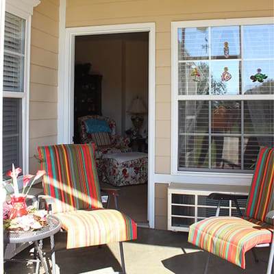Outdoor seating area with colorful chairs and decor
