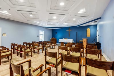 Interior view of a chapel with wooden chairs