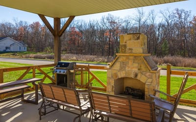 Outdoor seating area with fireplace and grill
