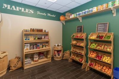 Indoor market area with food displays and signage
