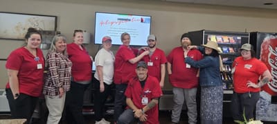 Staff members posing together in a common area