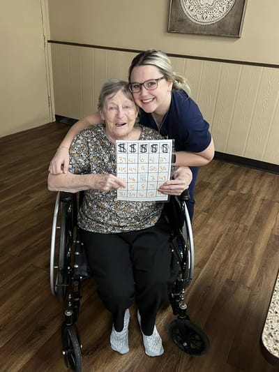 Resident and staff member celebrating bingo win