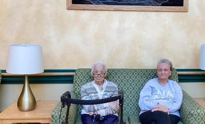 Two residents sitting in a cozy common area