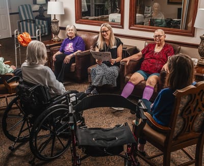 Residents and staff engaged in conversation in a common area