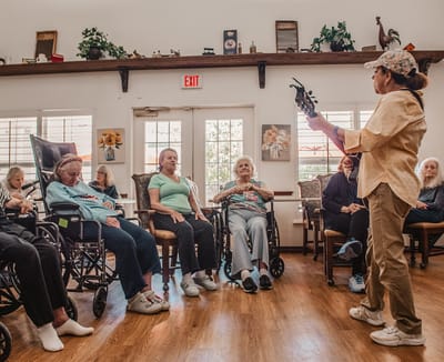 Residents enjoying a musical performance in a common area